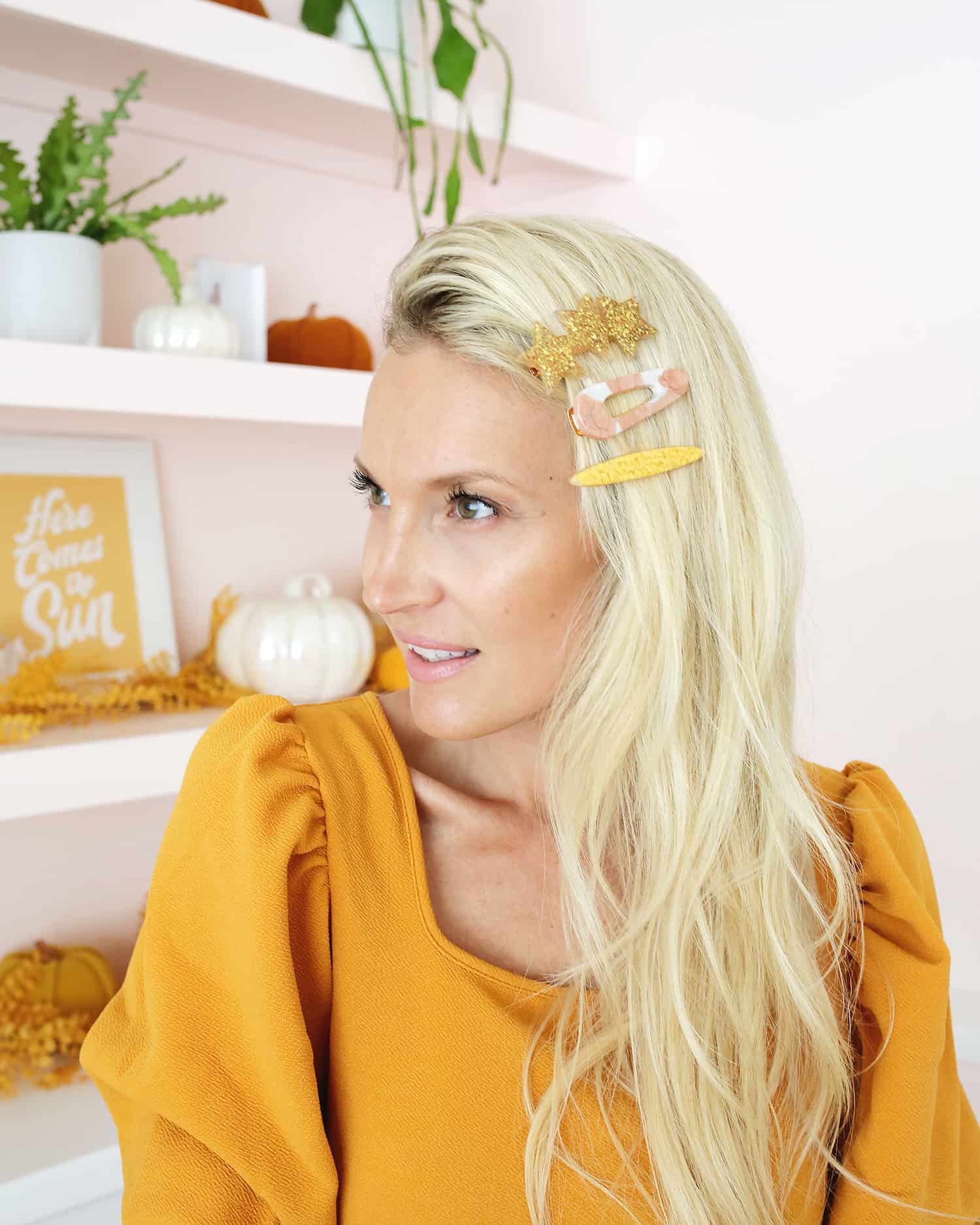 women with three large statement barrettes in curly hair