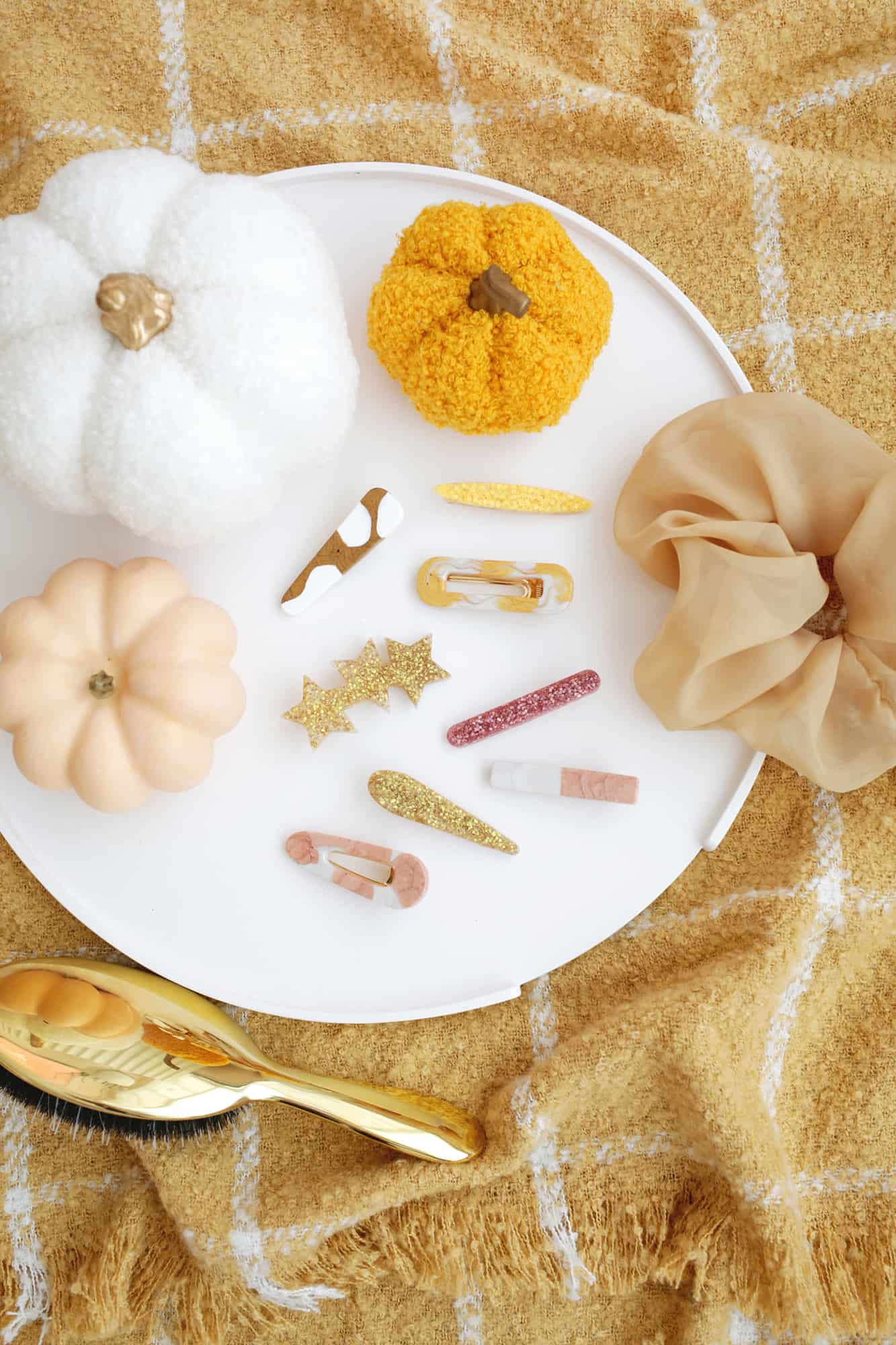 statement barrettes laying on white round tray