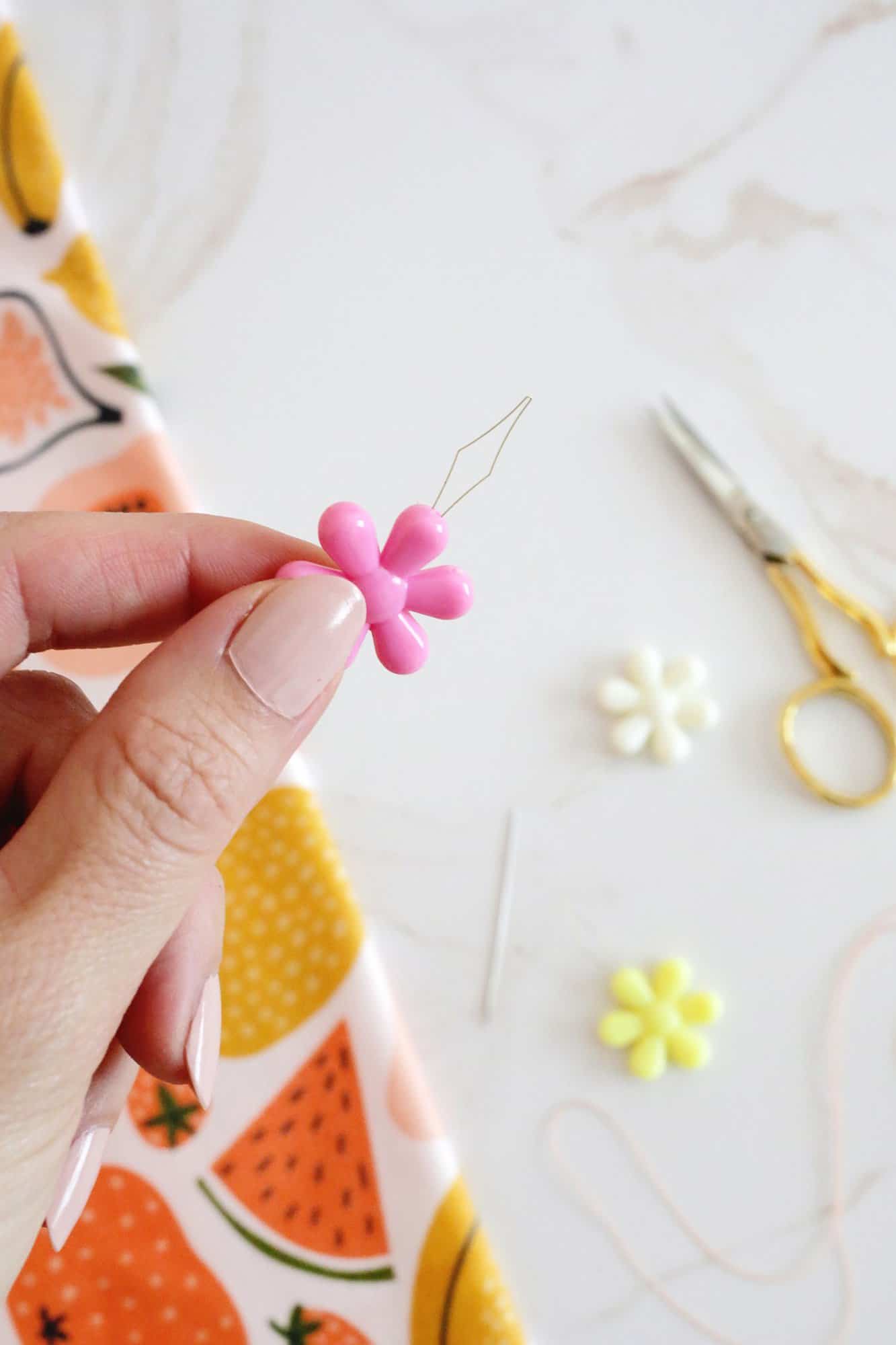 hand holding a needle threader